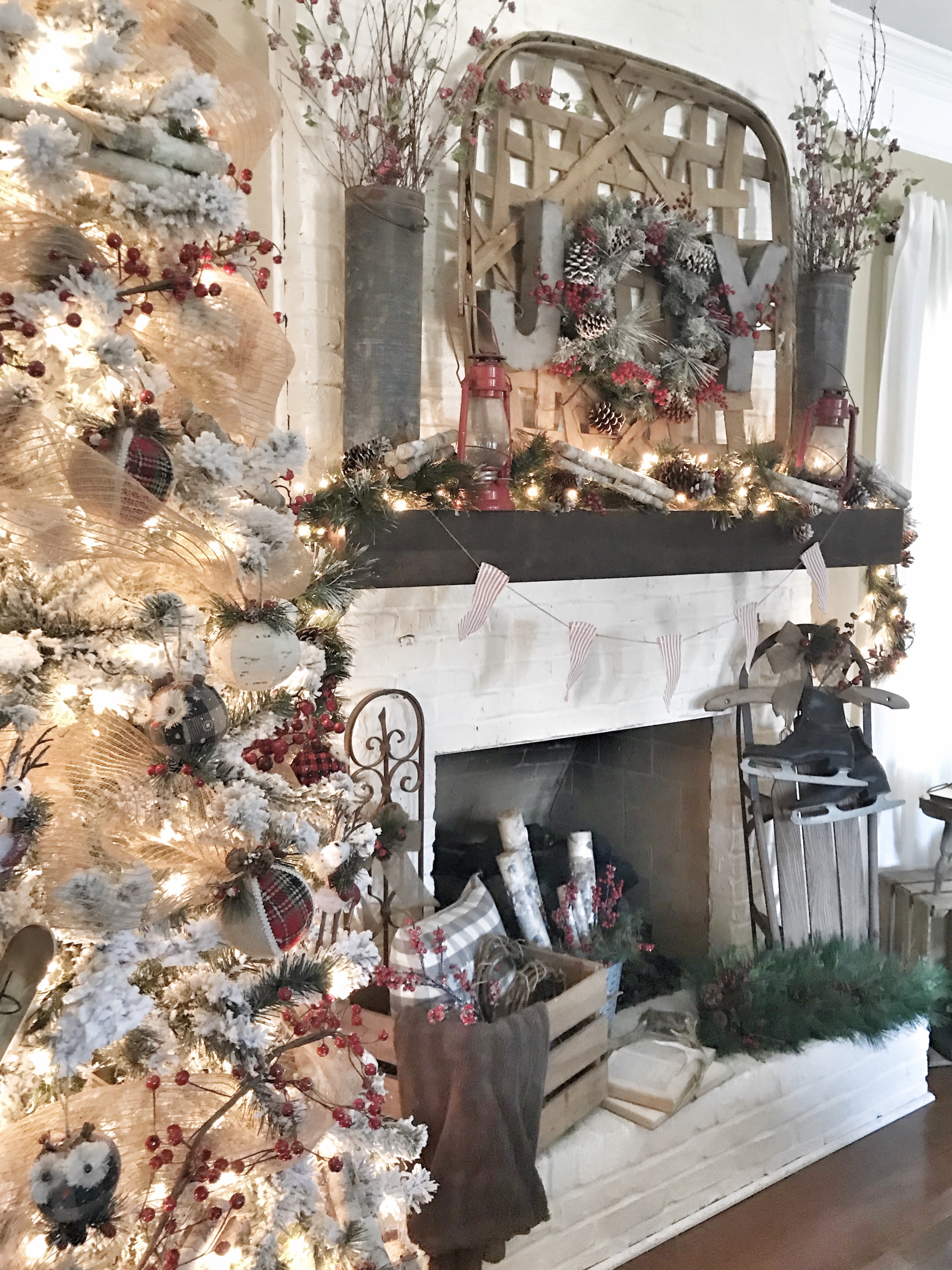 flocked Christmas tree and fireplace with Christmas decor