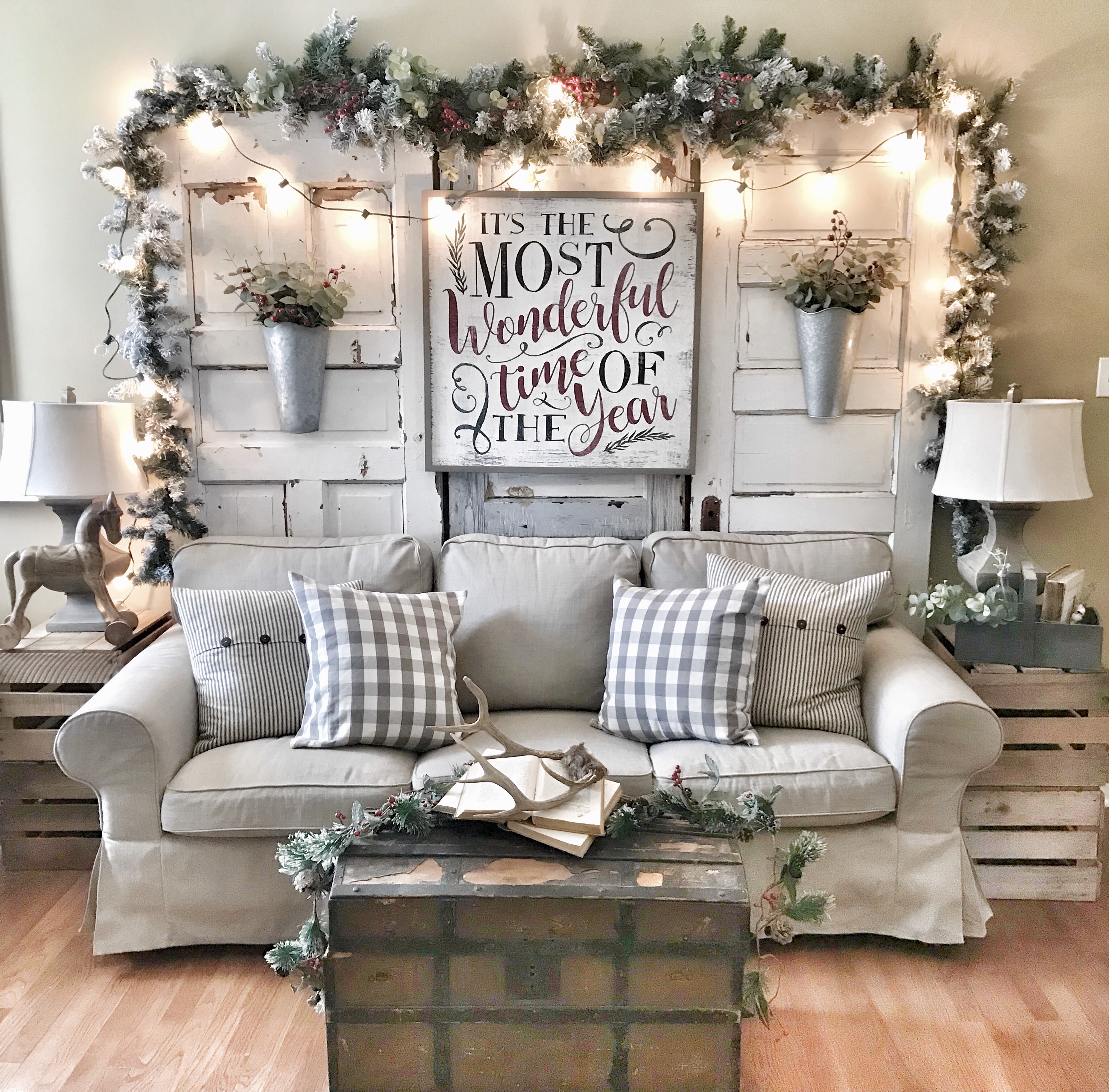 Christmas living room with garland, Christmas lights, and Christmas sign
