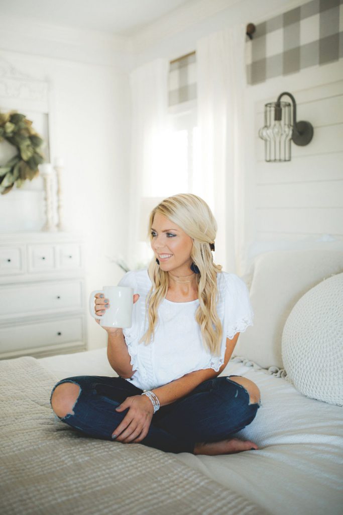 carissa with coffee cup on bed