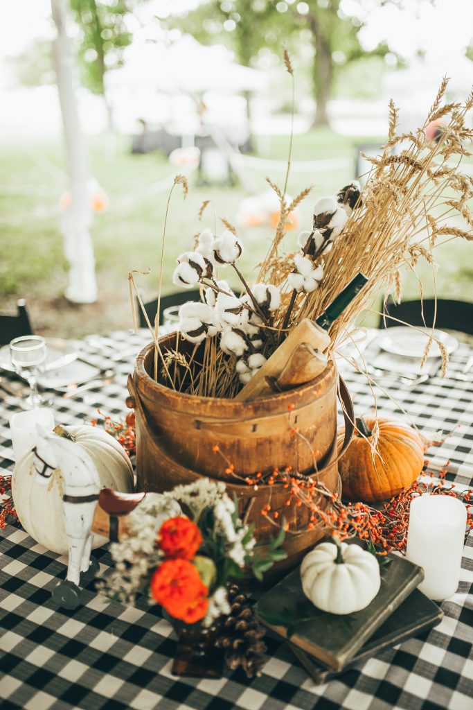 beautiful fall centerpiece with wheat, cotton, and pumpkins