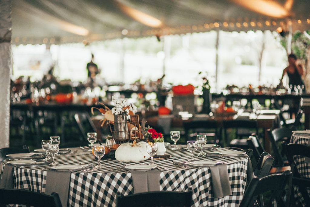 table decorated for fall with black and white checkered tablecloth