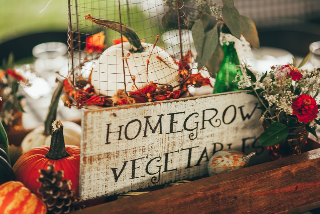 close up of fall centerpiece with vintage homegrown vegetables sign