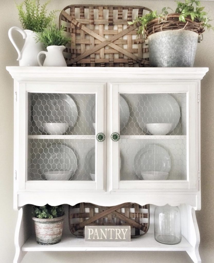 white wooden hutch decorated with small tobacco baskets