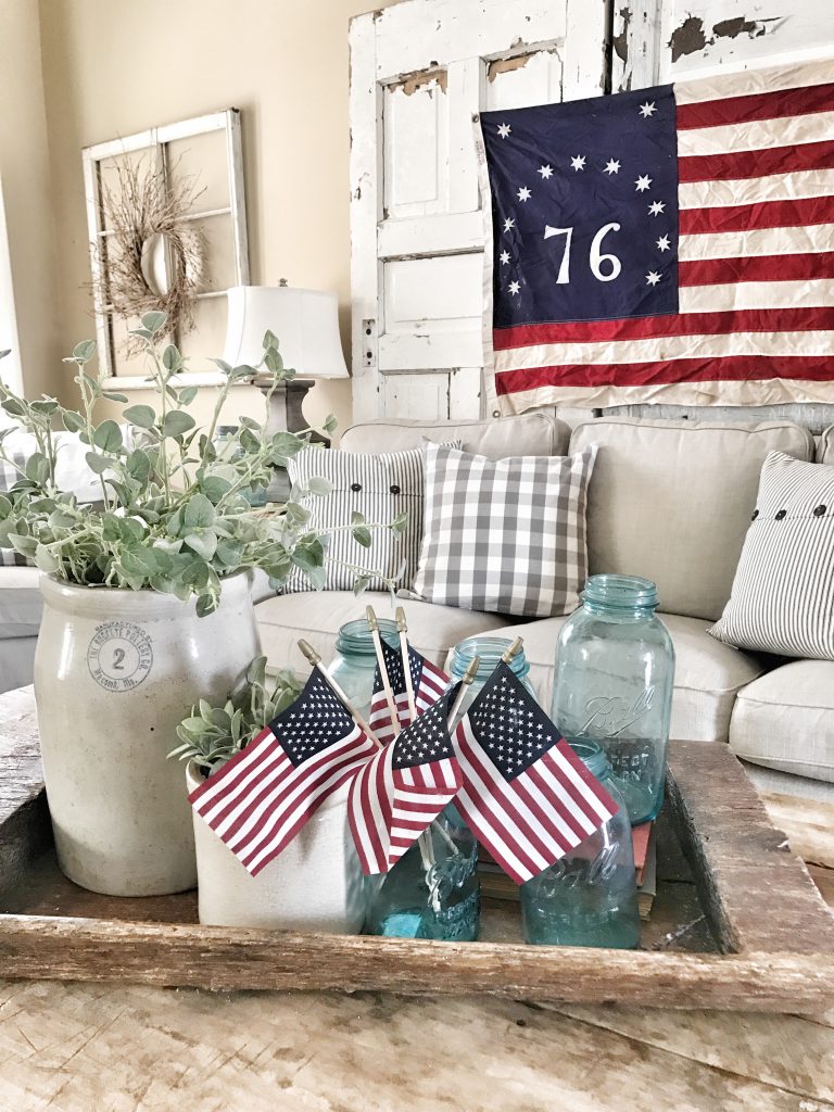 coffee table close up with blue mason jars and small us flags