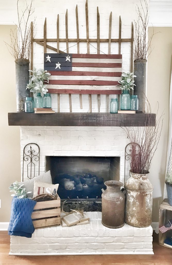 painted rustic us flag hung above living room mantel