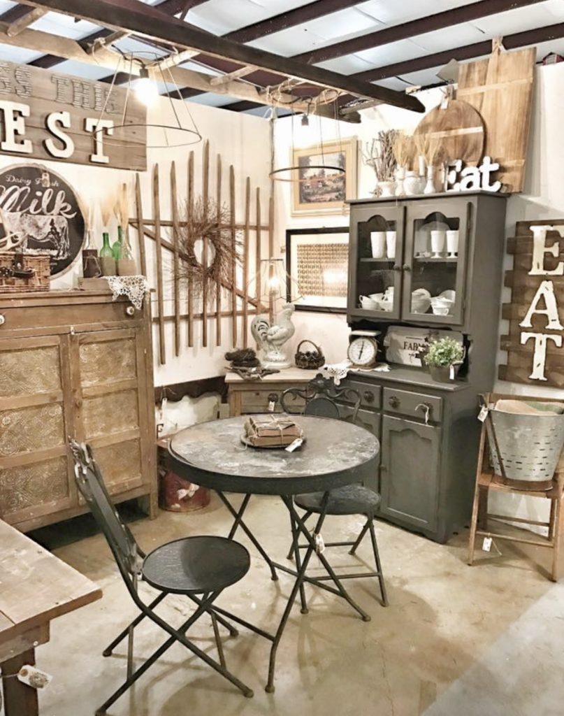 antique booth with farmhouse decor and black antique table