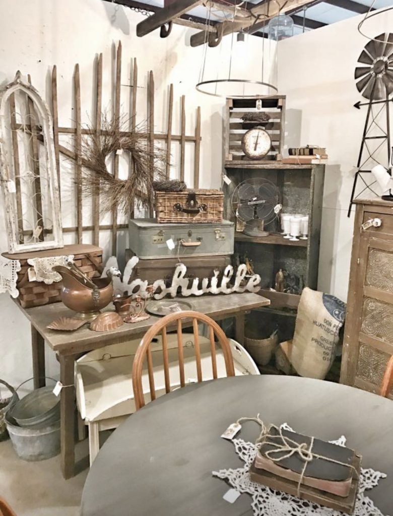 antique booth table with old suitcases and antiques