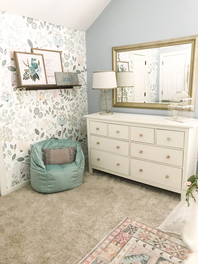 dresser and comfortable chair in girl's room