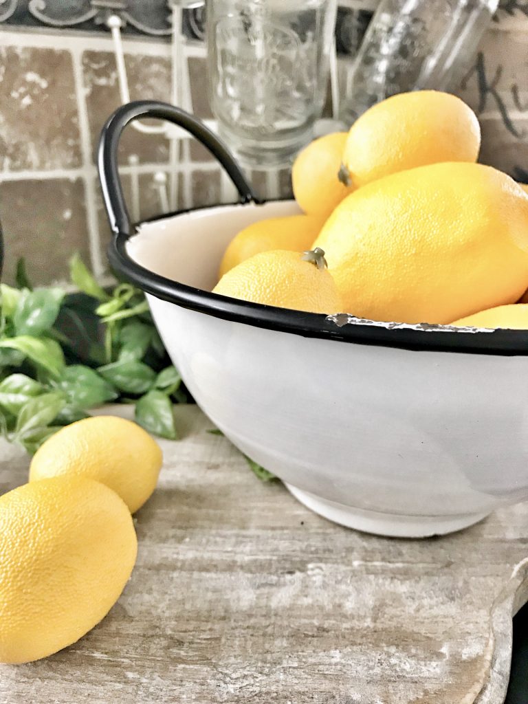 lemons in white bowl on kitchen counter