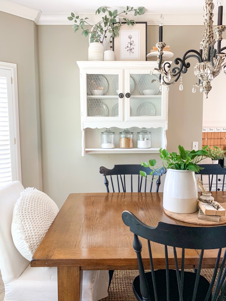 kitchen eating area with hanging hutch and farmhouse table