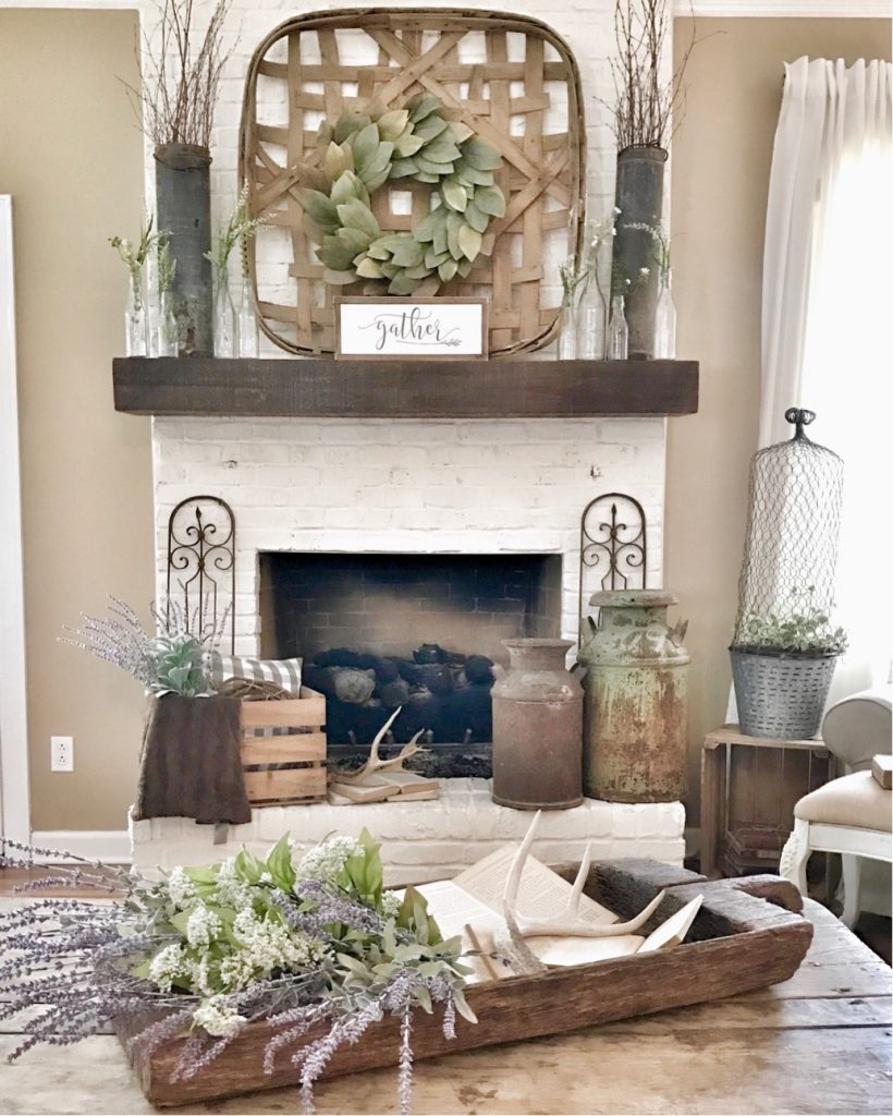 painted white fireplace with rustic decor 