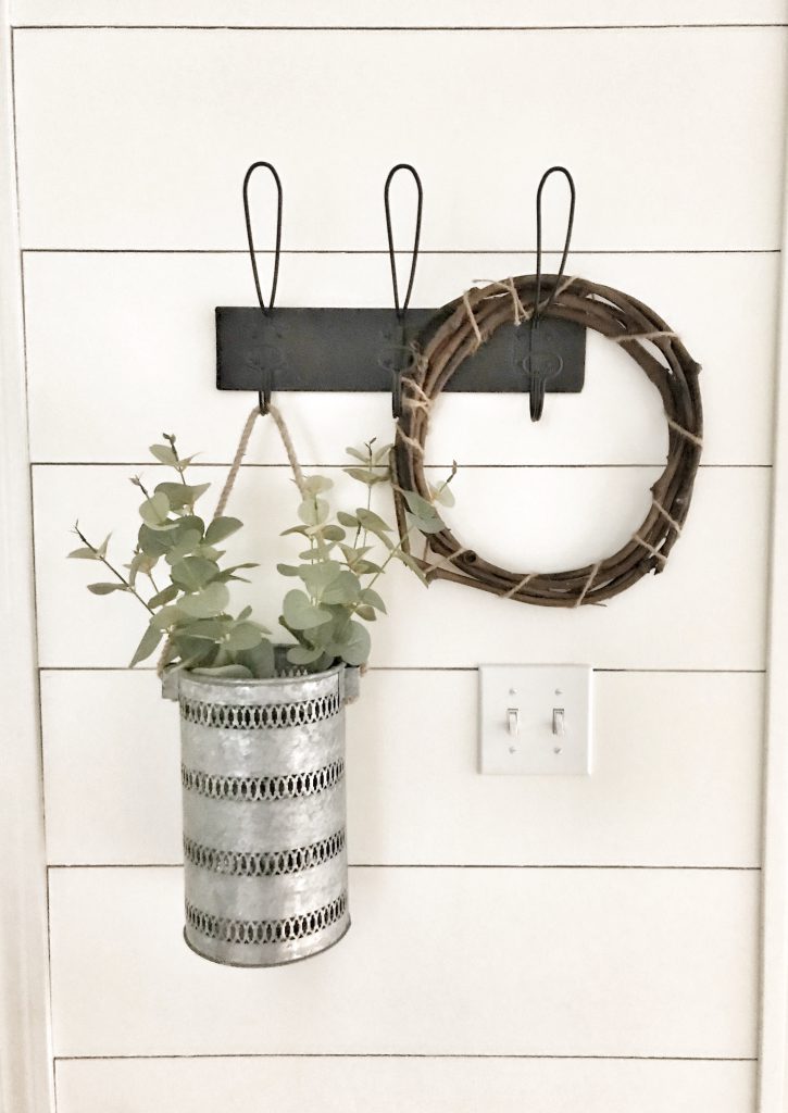hanging plant in metal basked and wooden wreath