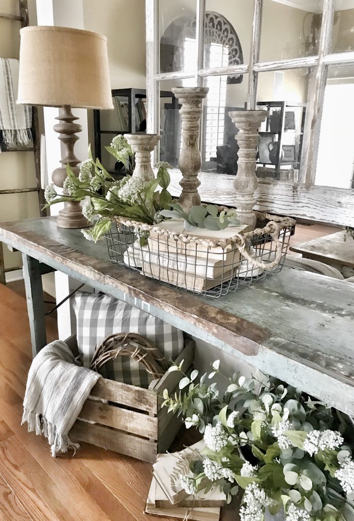 farmhouse console table decorated with old books