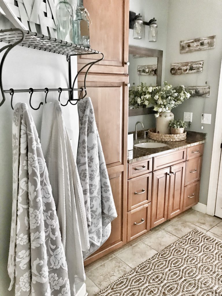 close up of towel rack with bathroom vanity in background