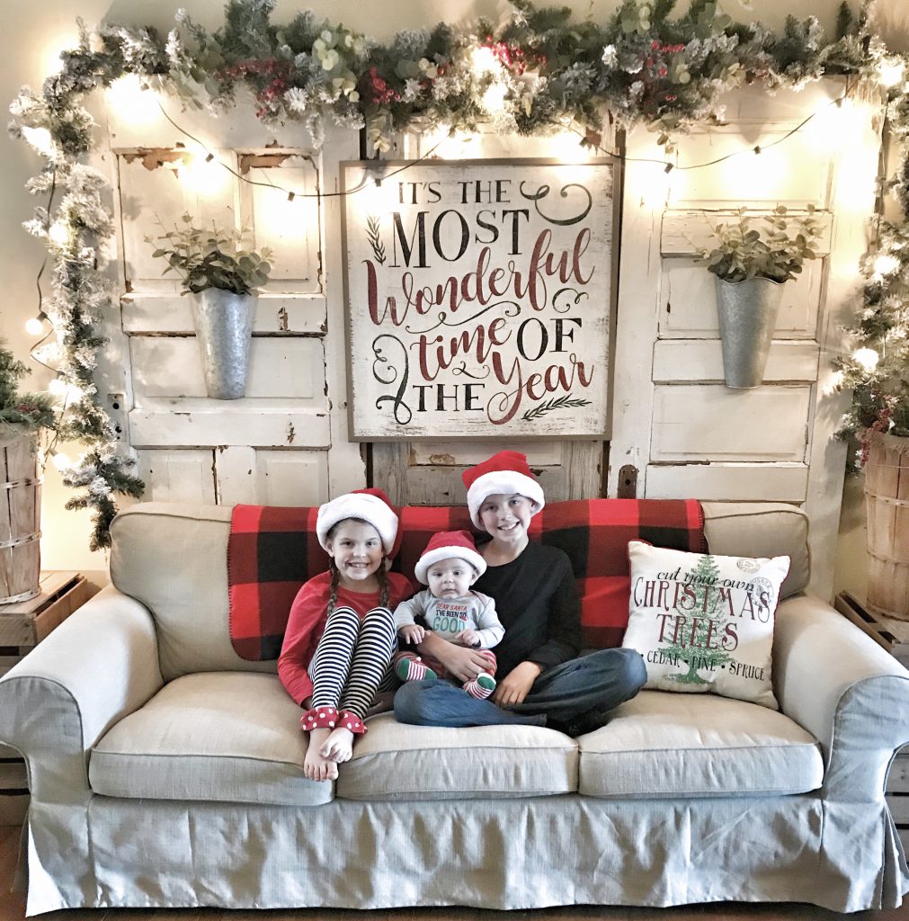 children on couch in Christmas decorated room